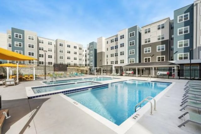 Swimming pool lounge chairs buildings exterior at Aspen Heights Bloomington in Bloomington Student Accommodation