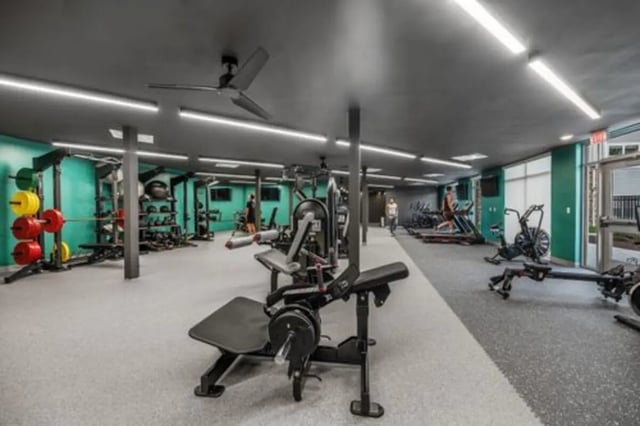 Weight rack treadmills exercise bikes gym living room at Aspen Heights Bloomington in Bloomington Student Accommodation