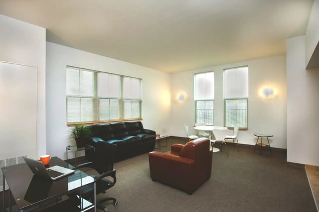 Sofa desk chair table and chairs living room at Collegetown Terrace Apartments in Ithaca Student Accommodation