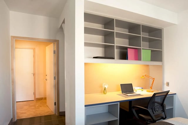 Desk with laptop and shelves study area at Collegetown Terrace Apartments in Ithaca Student Accommodation