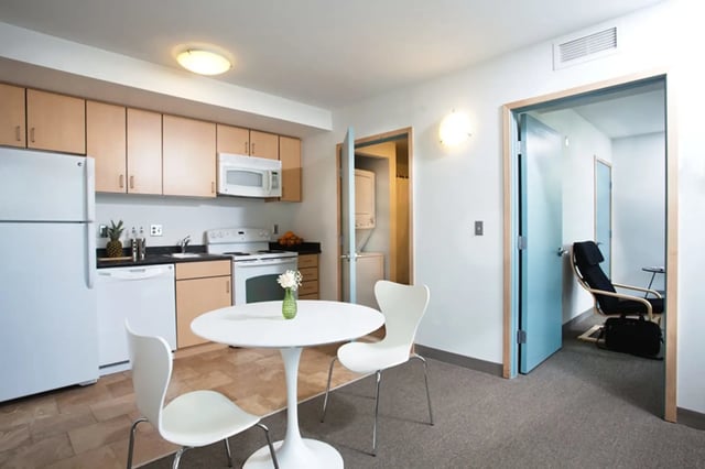 Kitchen with table chairs and laundry area at Collegetown Terrace Apartments in Ithaca Student Accommodation