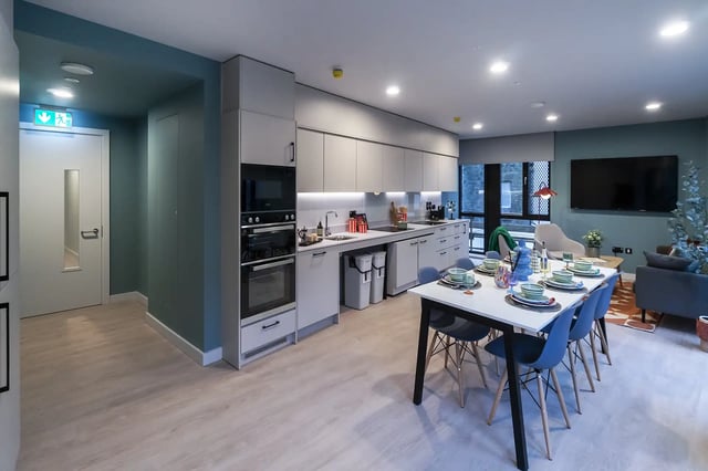 Modern student kitchen with dining area and living room. at Queen Street Place in Galway Student Accommodation