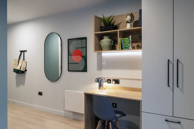 Oval mirror art shelf desk chair wardrobe study area at Queen Street Place in Galway Student Accommodation