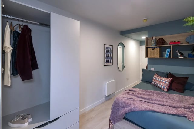 Wardrobe clothes shoes bed mirror shelves bedroom at Queen Street Place in Galway Student Accommodation