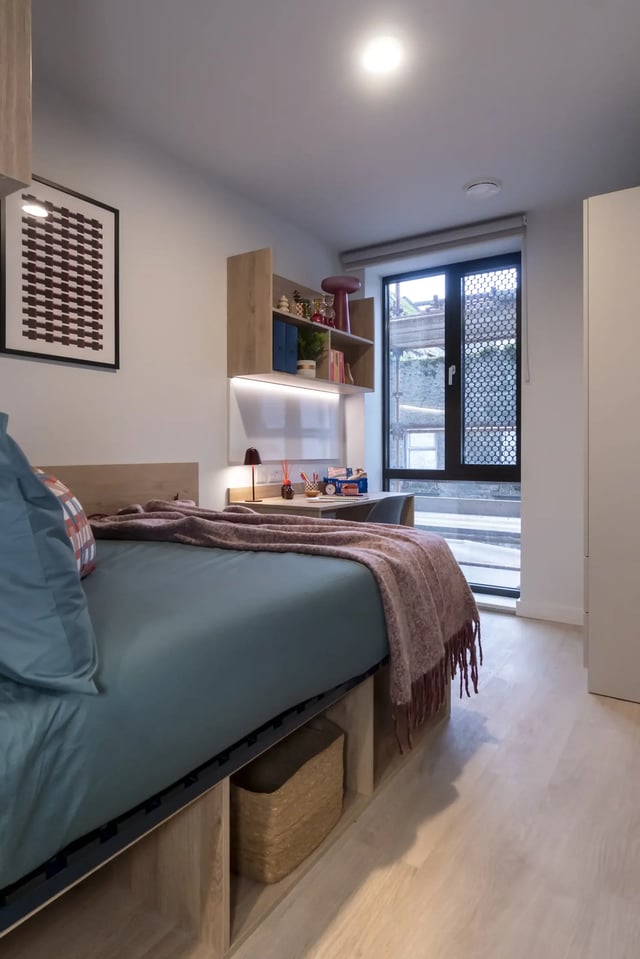 Bed desk shelves lamp artwork storage basket bedroom at Queen Street Place in Galway Student Accommodation