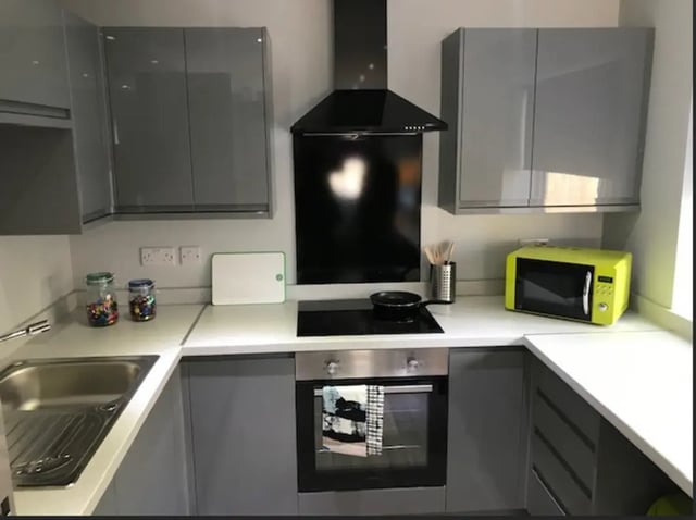 Modern grey kitchen with microwave oven and hob kitchen at Varsity Beeston in Nottingham Student Accommodation