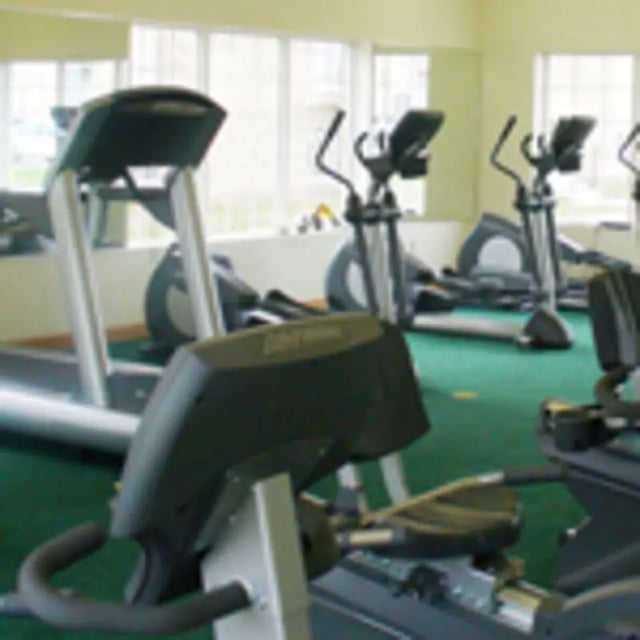 Treadmills and elliptical machines in gym Playing area at Aspen Court Apartments in Macomb Student Accommodation