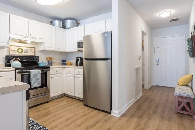 Stainless steel refrigerator white cabinets oven kitchen. at Belmont Landing in Farmville Student Accommodation