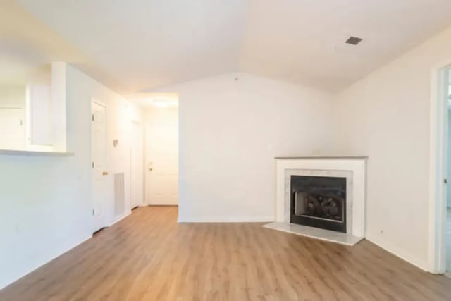 Fireplace and doorway with wooden floor Living Room at Belmont Landing in Farmville Student Accommodation