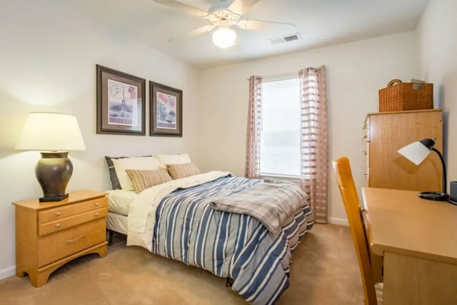 Bed desk lamp framed art nightstand bedroom at Belmont Landing in Farmville Student Accommodation