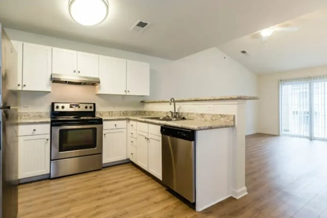 White cabinets stainless steel stove dishwasher kitchen at Belmont Landing in Farmville Student Accommodation