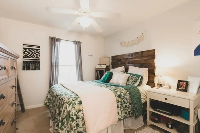 Bed with floral bedding wooden headboard nightstand bedroom at Belmont Landing in Farmville Student Accommodation