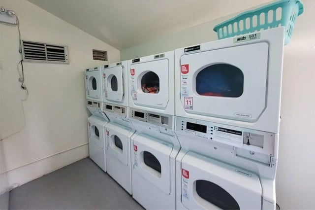Stacked washers and dryers laundry area at Colony Studios and Apartments in Reno Student Accommodation