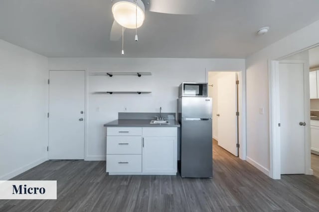 Fridge microwave sink cabinets and door Kitchen at Colony Studios and Apartments in Reno Student Accommodation
