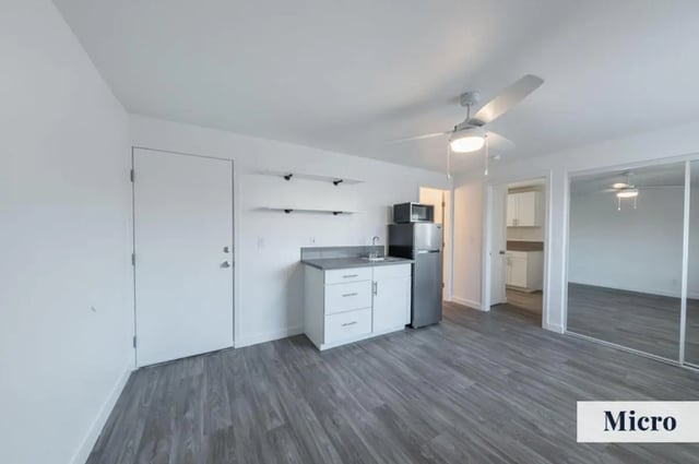 Compact kitchen with microwave and refrigerator Micro studio at Colony Studios and Apartments in Reno Student Accommodation