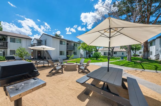 Grill picnic table chairs fire pit exterior at Colony Studios and Apartments in Reno Student Accommodation