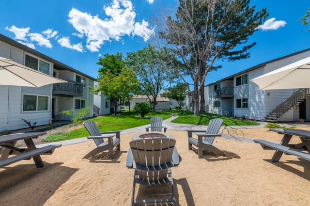 Adirondack chairs picnic tables fire pit exterior at Colony Studios and Apartments in Reno Student Accommodation