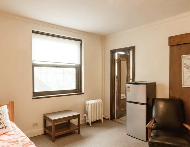 Bed refrigerator chair radiator table bedroom at 5748 Blackstone by 3L Living in Chicago Student Accommodation