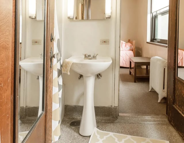 Two sinks and bedrooms visible Bathroom and bedroom. at 5748 Blackstone by 3L Living in Chicago Student Accommodation