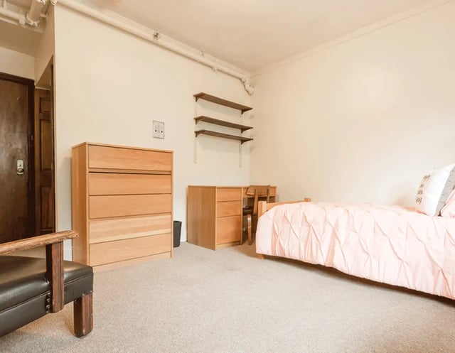 Bed dresser desk shelves chair bedroom at 5748 Blackstone by 3L Living in Chicago Student Accommodation