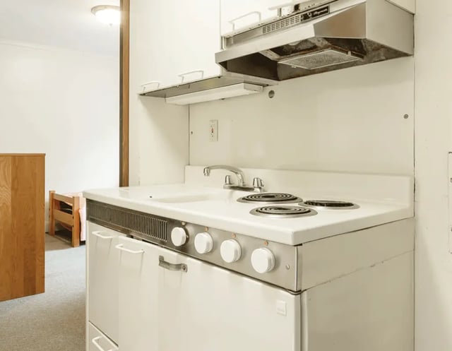 White sink stovetop and cabinets kitchen area at 5748 Blackstone by 3L Living in Chicago Student Accommodation