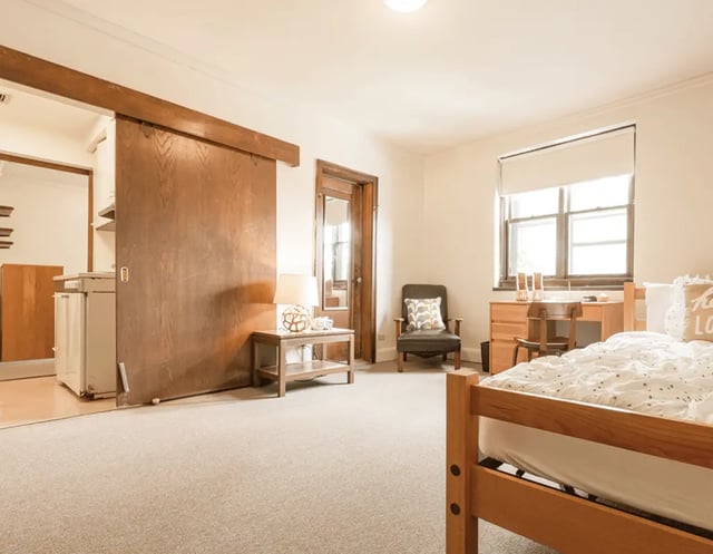 Bed desk chair and small kitchen area bedroom at 5748 Blackstone by 3L Living in Chicago Student Accommodation