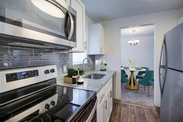Modern kitchen with stainless steel appliances dining area kitchen at Brockport Crossings Apartments & Townhomes in Brockport Student Accommodation
