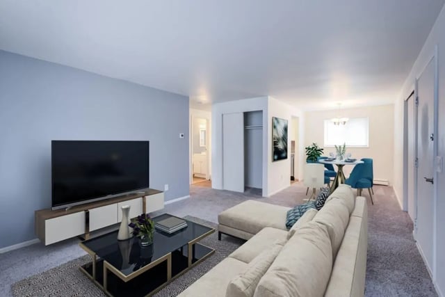 Sofa TV dining table chairs living room at Brockport Crossings Apartments & Townhomes in Brockport Student Accommodation