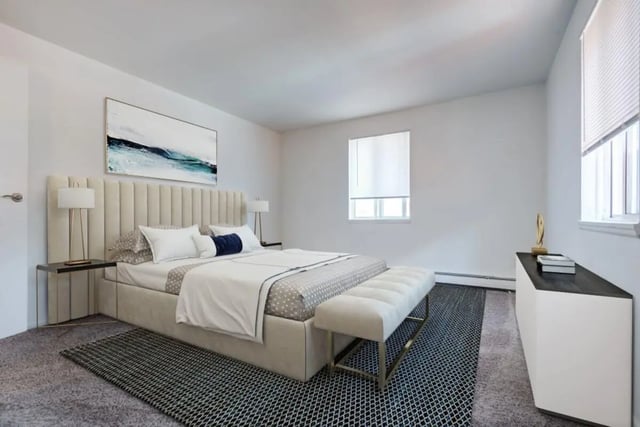 Upholstered bed with artwork and bench Bedroom at Brockport Crossings Apartments & Townhomes in Brockport Student Accommodation