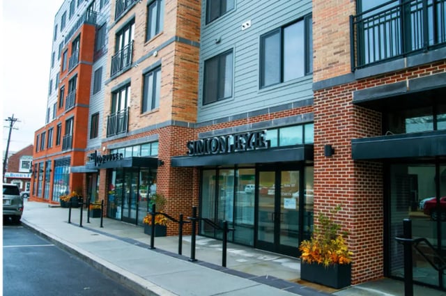 Modern building with brick and grey siding exterior exterior at 58 E. Main St. Apartments in Newark Student Accommodation