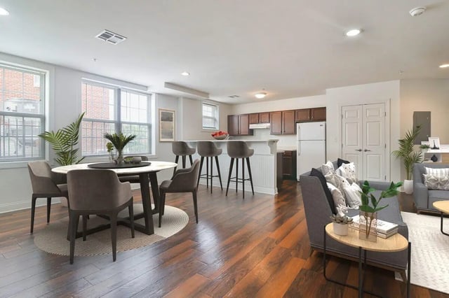 Dining table chairs kitchen island living room living room at 58 E. Main St. Apartments in Newark Student Accommodation