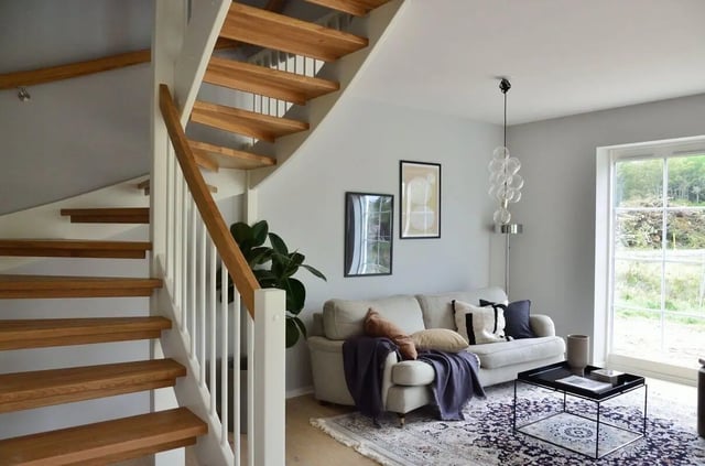 Wooden stairs sofa and coffee table living room at Benson Management, Inc. in La Crosse Student Accommodation
