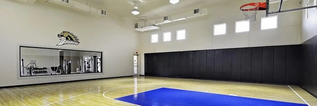 Gymnasium with basketball court and gym equipment viewing area at 58 West - Lease by Bed Available in Kalamazoo Student Accommodation