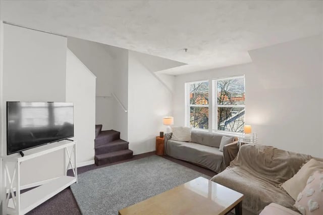 Sofa TV stairs and windows living room at Cedar Lofts East Apartments in State College Student Accommodation