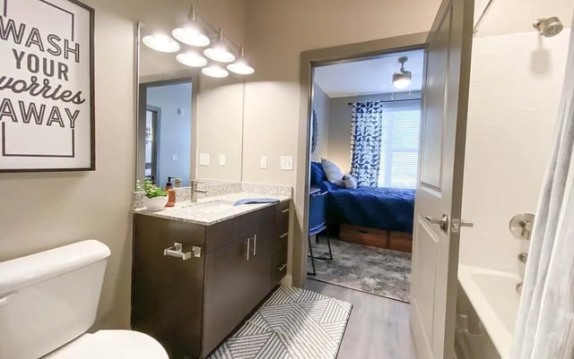 Toilet sink vanity shower and bedroom view Bathroom bedroom at Cedar Pointe Apartments in Blacksburg Student Accommodation