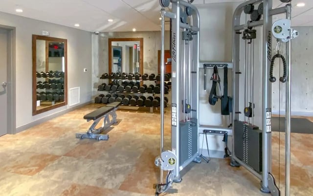 Dumbbells weights bench and cable machine gym at Cedar Pointe Apartments in Blacksburg Student Accommodation