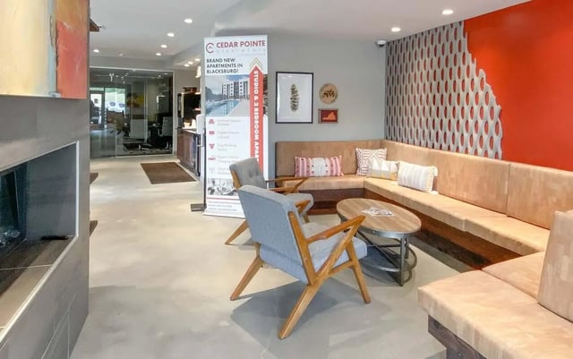 Comfortable seating area with plush cushions and coffee table living room at Cedar Pointe Apartments in Blacksburg Student Accommodation