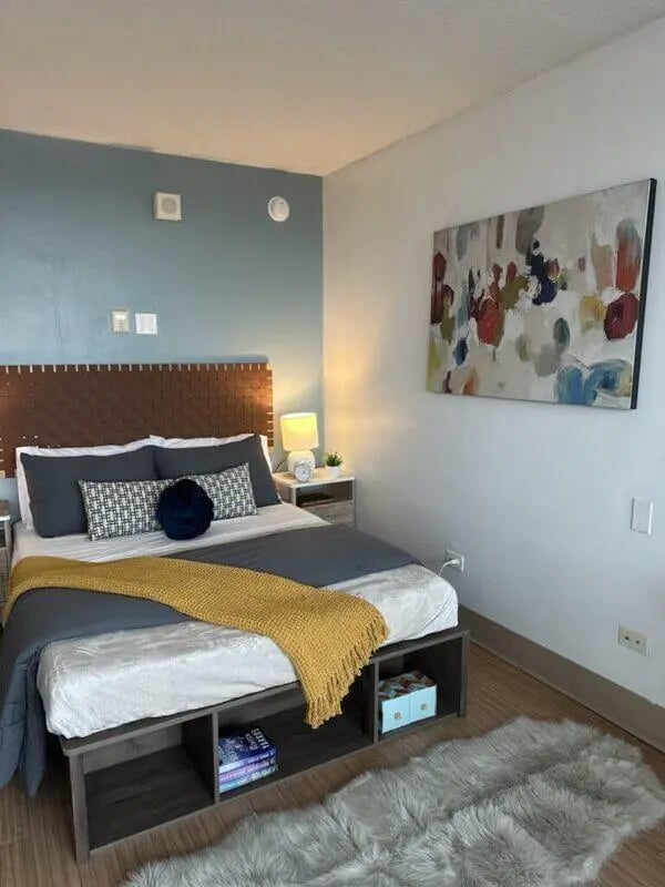 Bed with storage, artwork, and rug bedroom at Assembly Student Living in Denver Student Accommodation