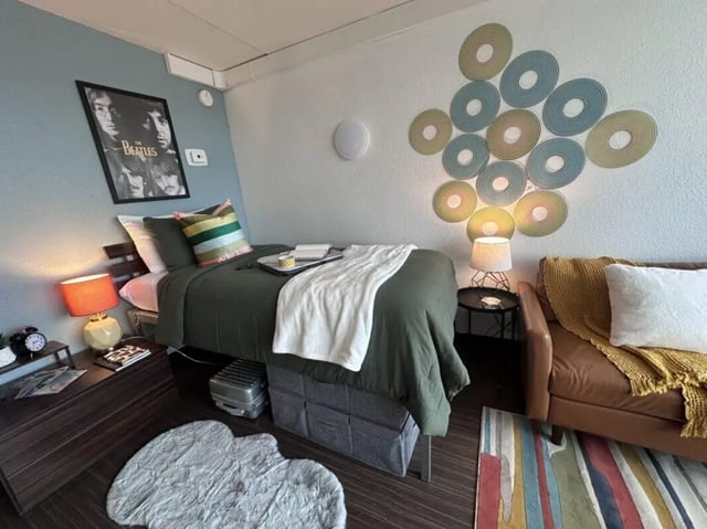 Bed Beatles poster sofa rug Bedroom at Assembly Student Living in Denver Student Accommodation