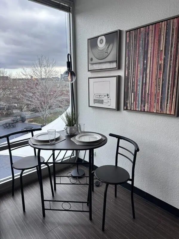 Table chairs plates glasses artwork dining area at Assembly Student Living in Denver Student Accommodation