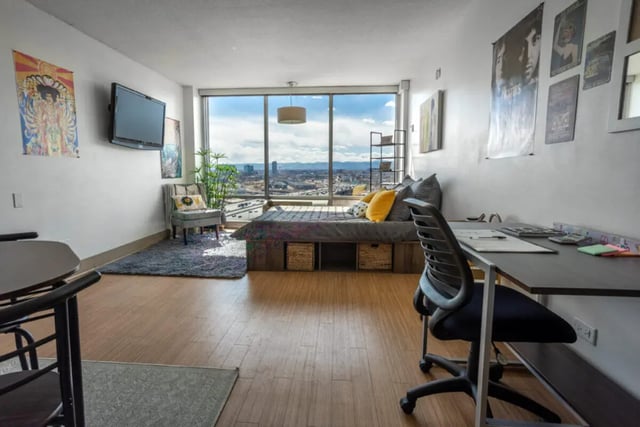 Bed desk chair chair rug with city view bedroom at Assembly Student Living in Denver Student Accommodation