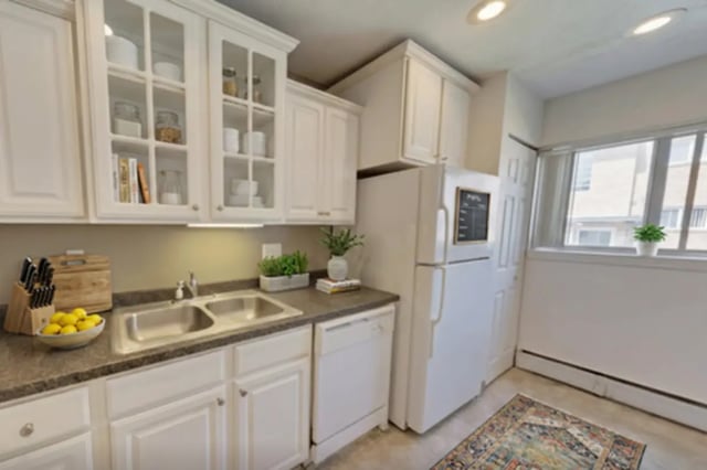 White cabinets sink dishwasher refrigerator kitchen at Cedar Street Apartments in East Lansing Student Accommodation