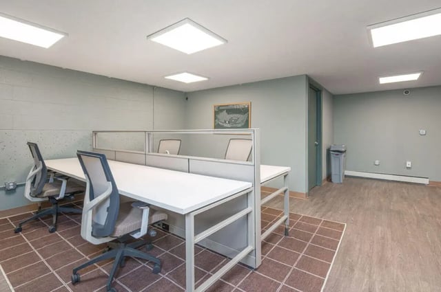 Desks chairs cubicle walls study area at Cedar Street Apartments in East Lansing Student Accommodation