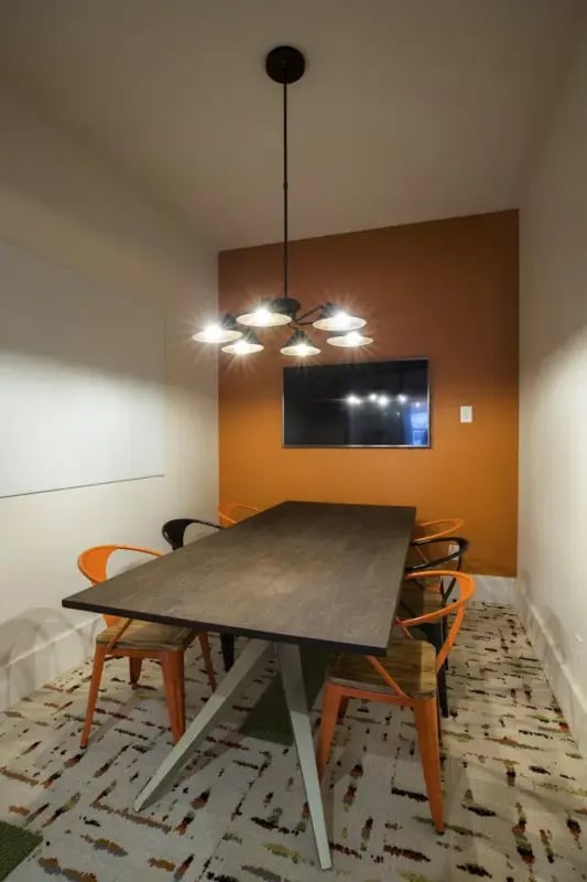 Table chairs television whiteboard common area at Annex in Oxford Student Accommodation