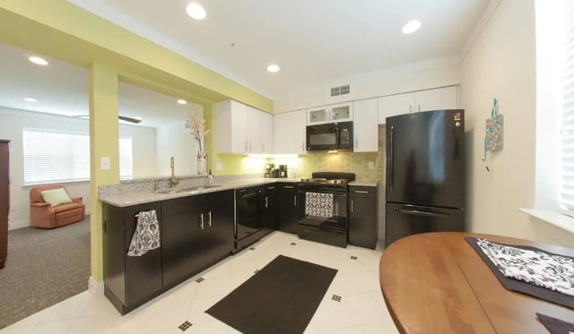 Black refrigerator oven cabinets sink kitchen at Deco '39 Luxury Apartments in Gainesville Student Accommodation