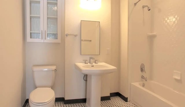 Toilet sink cabinet shower tub bathroom at Deco '39 Luxury Apartments in Gainesville Student Accommodation