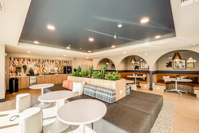 Lounge with coffee bar banquette seating communal area at Aperture in Orlando Student Accommodation