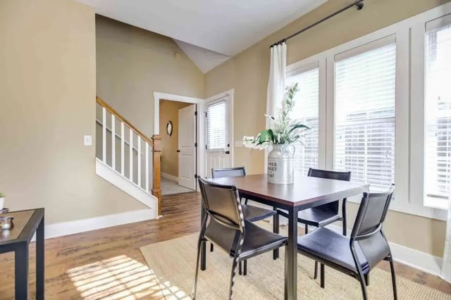 Table with chairs and staircase dining area at Cottages of Clemson in Central Student Accommodation