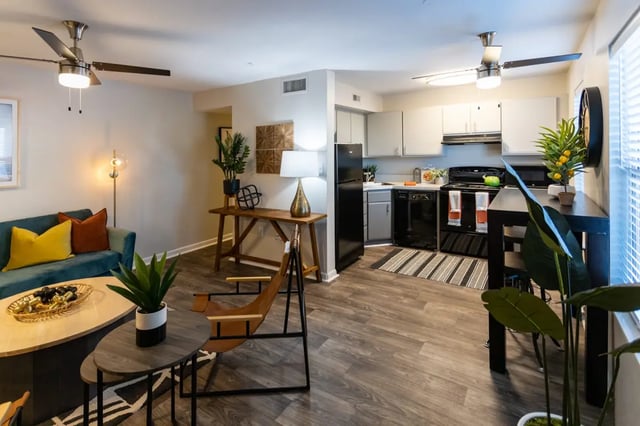 Sofa chairs tables kitchen appliances living room kitchen at Highland Grand Apartments in Knoxville Student Accommodation