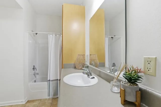 Sink shower curtain and plant bathroom at Legacy Student Living in Tallahassee Student Accommodation